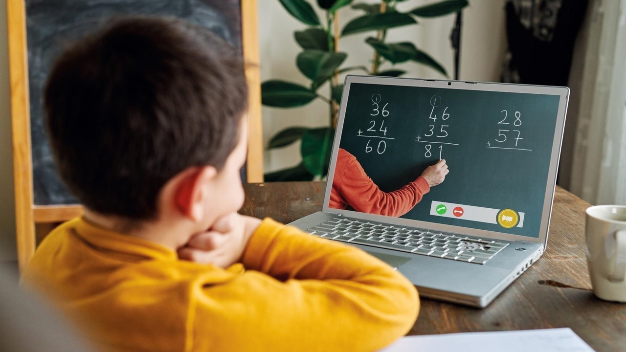 Child learning math on a tablet with colorful interface