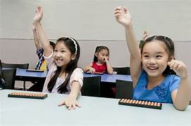 Child succeeding at school math with soroban background