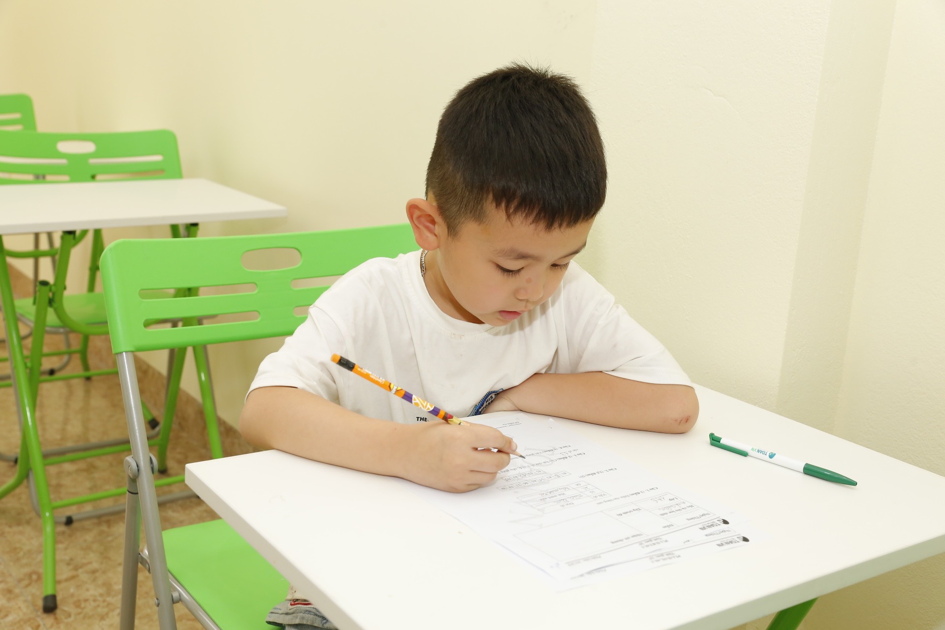 Asian child focused on learning math at their own pace