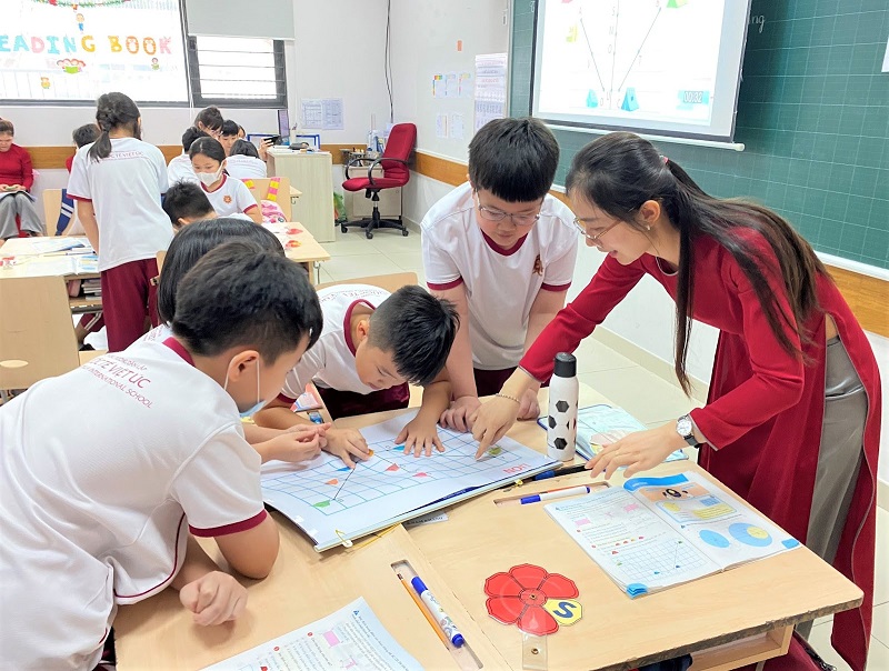 Teacher and students in active learning classroom with group activities