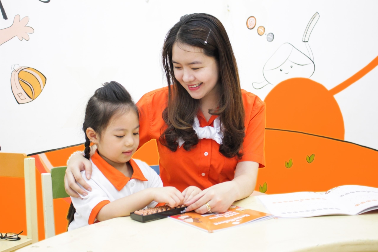 Family learning Soroban at home with both physical abacus and tablet