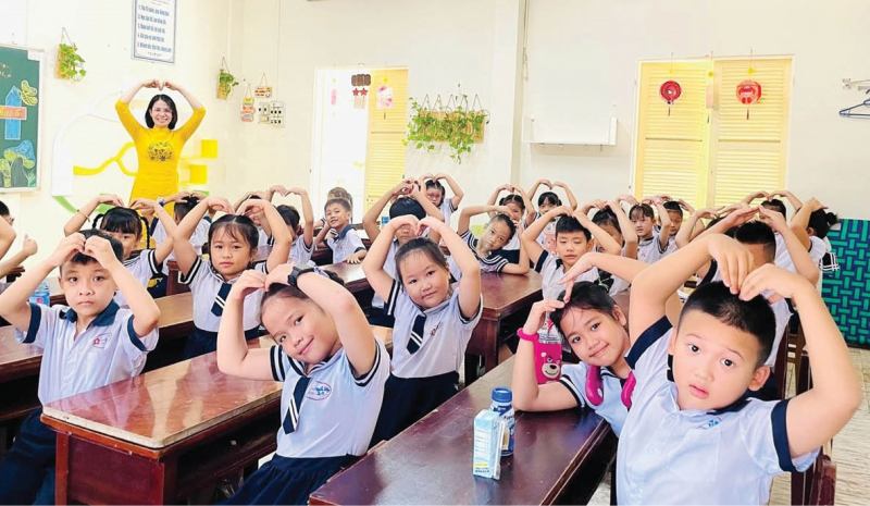 Teacher leading an engaging warmup activity with elementary students