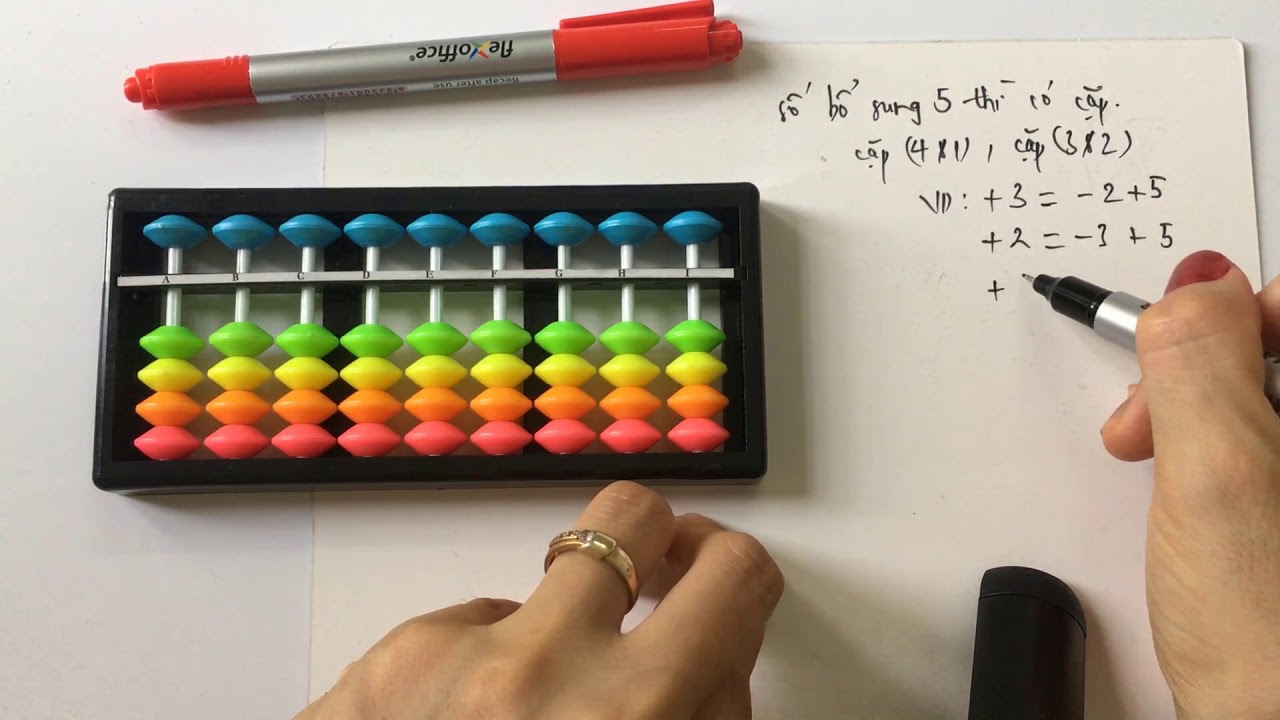 Child learning mental math with Soroban abacus