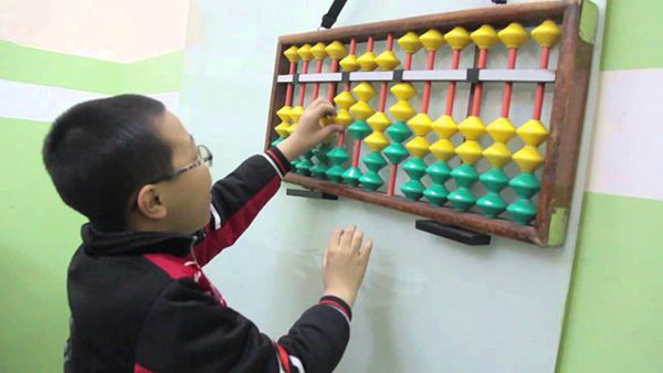 Child learning math independently at home